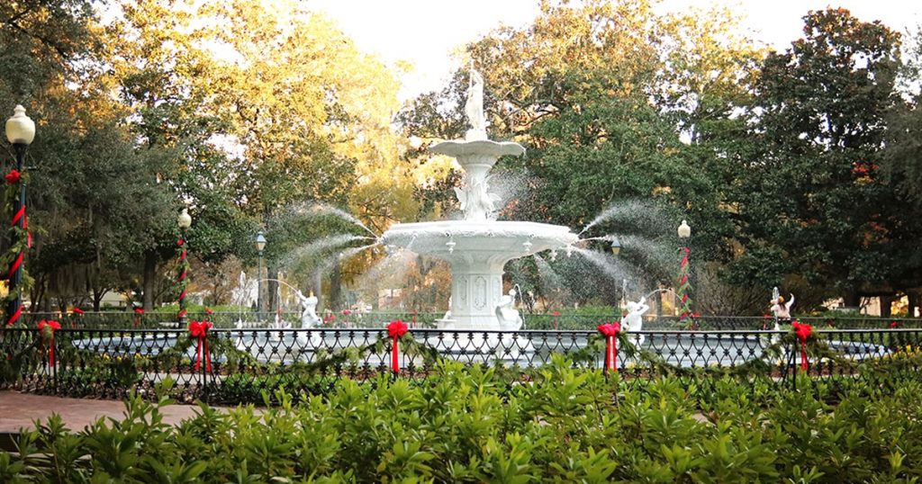 Forsyth Park with its famous fountain surrounded by vibrant flowers.