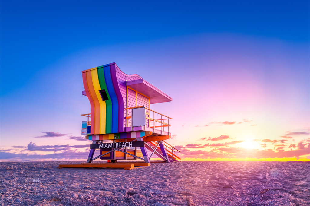 A dynamic beach scene at South Beach, with turquoise waters and colorful lifeguard towers the best places to visit in april.